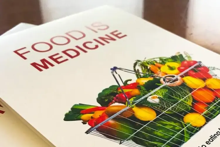 A Food Is Medicine guide with a basket of colorful fresh vegetables