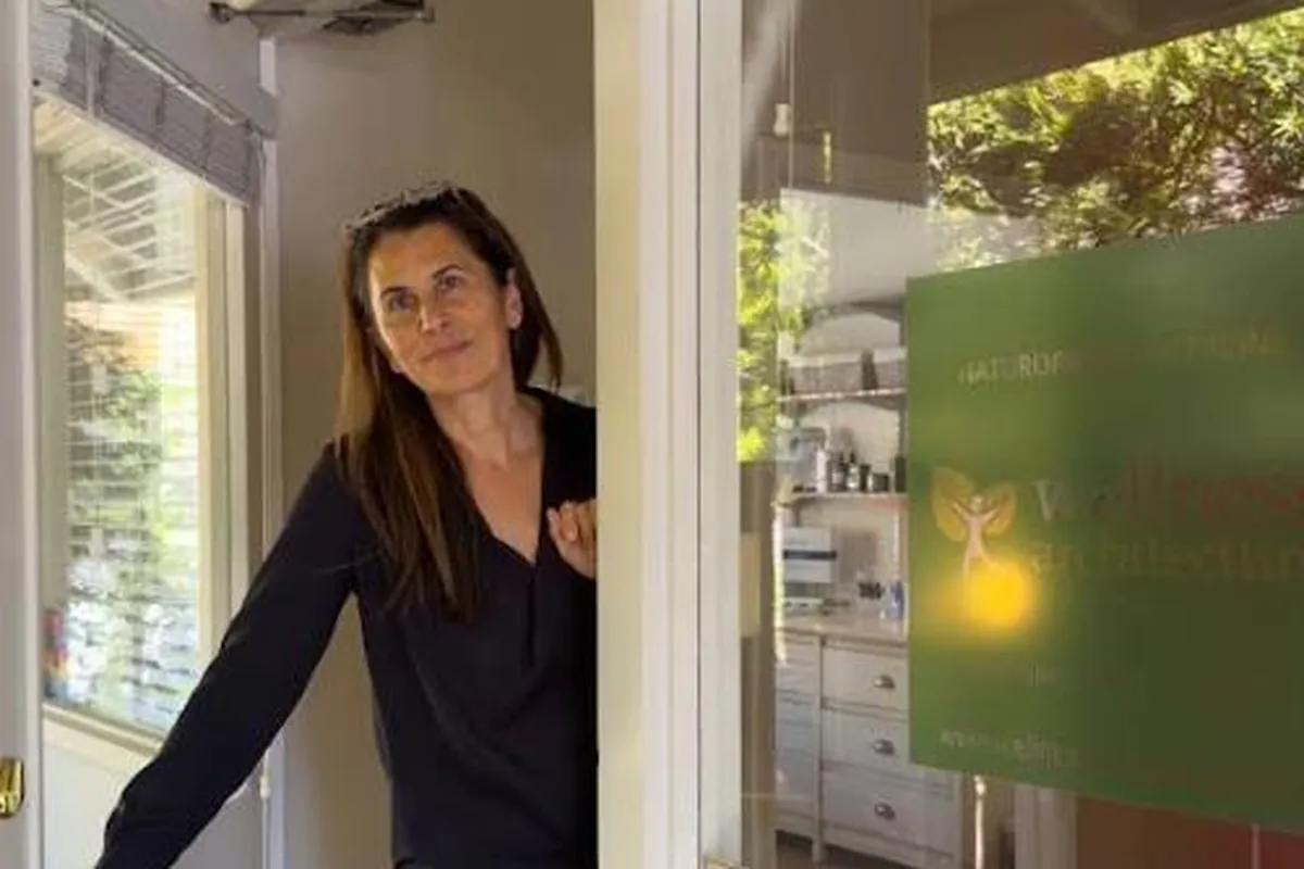 Dr. Samia McCully, ND welcoming visitors at the Wellness Architecture clinic door